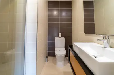 a bathroom with a toilet and a sink and a shower at Villa Maria in Albufeira