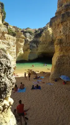 a group of people on a beach in a cave at Quinta do Pinheiro Residence in Albufeira