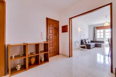 a living room with a couch and a table at Rei - Quarteira - 3 min to the beach in Vilamoura