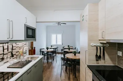 a kitchen with a sink and a table with chairs at DREAMS HOUSE in Faro
