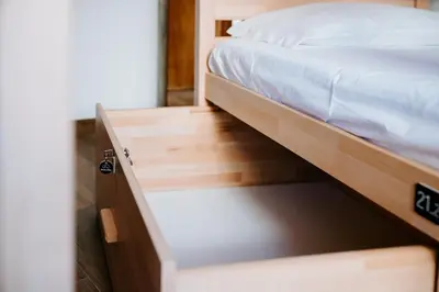 a bed in a room with a wooden bed frame at DREAMS HOUSE in Faro