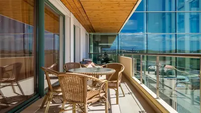 a balcony with a table and chairs and windows at Marina Vilamoura - Aquamar 120 - By Vilamoura Sun in Vilamoura
