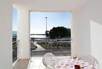 a balcony with a table and chairs and a view at Apt Baleeira Sol in Albufeira