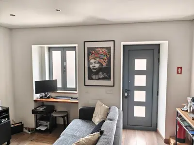 a living room with a couch and a desk at The Old Town House by Freetimealgarve in Faro