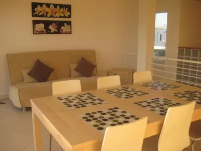 a living room with a chess board on a table at Villas Oceano in Albufeira