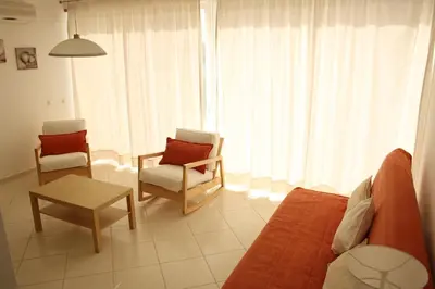 a living room with a couch and chairs and a table at Villas Oceano in Albufeira