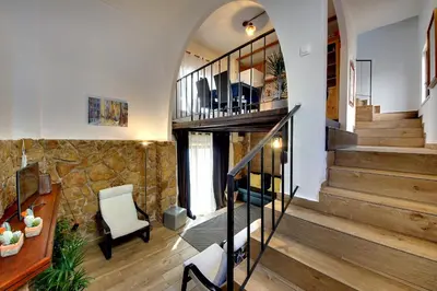 a staircase in a home with a stone wall at CASA 4 - Perfect location - Sea view by DreamvillasAlbufeira in Albufeira