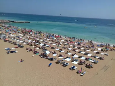 a beach with a lot of chairs and umbrellas at CASA 4 - Perfect location - Sea view by DreamvillasAlbufeira in Albufeira