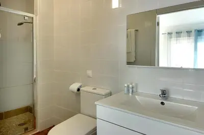 a bathroom with a toilet and a sink and a mirror at CASA 4 - Perfect location - Sea view by DreamvillasAlbufeira in Albufeira