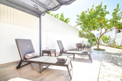 two chairs and a table on a patio at Casa dos Avós by MTPhomes in Albufeira