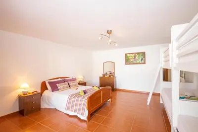a bedroom with a bed and a bunk bed at Villa Casa Castelo by Algarve Vacation in Albufeira