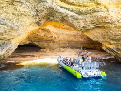 a group of people on a boat in front of a cave at Villa Casa Castelo by Algarve Vacation in Albufeira