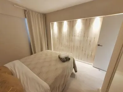 a bedroom with a bed and a wall at Old Town Apartment 5min to the beach in Albufeira
