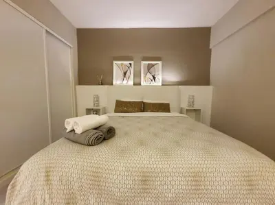 a bedroom with a large bed with two towels on it at Old Town Apartment 5min to the beach in Albufeira