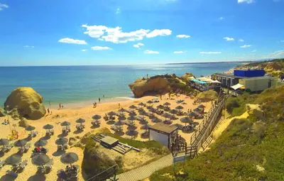 a beach with a bunch of umbrellas and the ocean at Apartment MargemSul - Pool - Beach - Free Wifi - Air Con in Albufeira