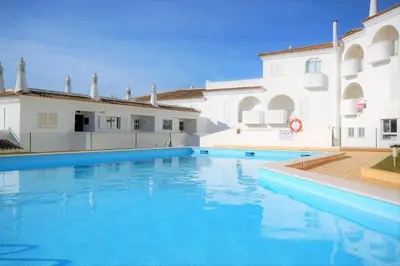 a large swimming pool in front of a building at Apartment MargemSul - Pool - Beach - Free Wifi - Air Con in Albufeira