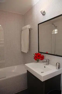 a bathroom with a sink and a mirror and a tub at Acoteias Studio by be@home in Albufeira