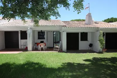 a white house with a table and chairs at Acoteias Studio by be@home in Albufeira