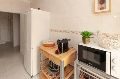 a small kitchen with a microwave and a counter at Waves by OCvillas in Albufeira