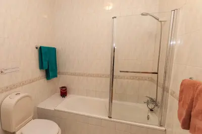 a bathroom with a tub and a toilet and a shower at Waves by OCvillas in Albufeira