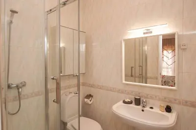 a bathroom with a shower and a toilet and a sink at Waves by OCvillas in Albufeira