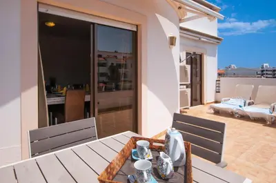 a balcony with a table and chairs on a patio at Waves by OCvillas in Albufeira