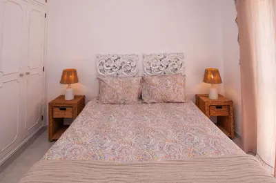 a bedroom with a large bed with two night stands at Waves by OCvillas in Albufeira