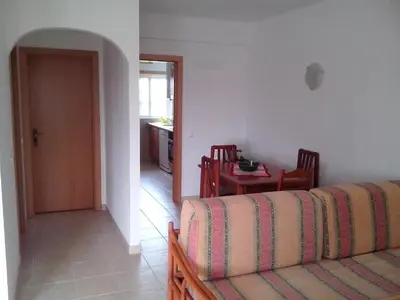 a living room with a couch and a table at Albufeira 1 bedroom apartment 5 min from Falesia beach and close to center D in Albufeira