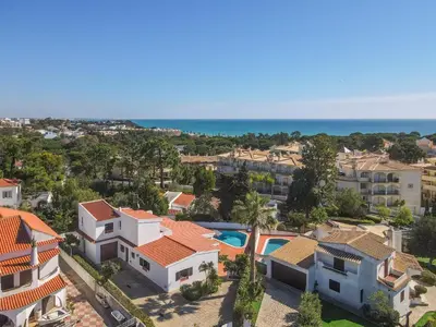 an aerial view of a residential neighborhood with houses and the ocean at Casa das Anas by HelloVacations in Albufeira