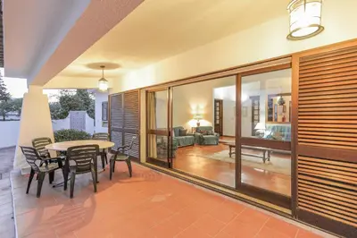 a dining room with a table and chairs at Casa das Anas by HelloVacations in Albufeira