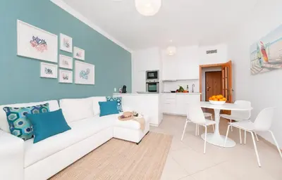 a living room with a white couch and a table at Apartamento Oura - BlueSea in Albufeira