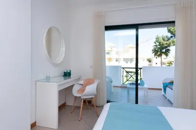 a bedroom with a bed and a desk and a mirror at Santa Eulália Apartment Luxury - Blue Sea in Albufeira