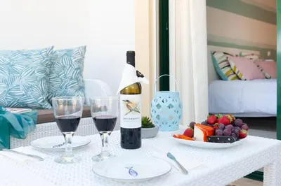 a table with a bottle of wine and two glasses at Santa Eulália Apartment Luxury - Blue Sea in Albufeira