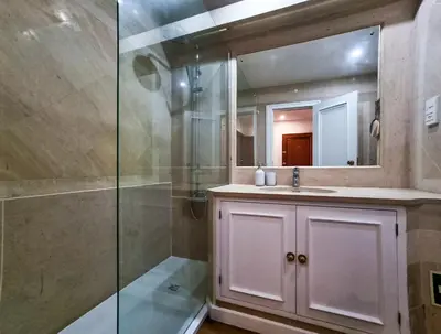 a bathroom with a shower and a sink and a mirror at FLH Vilamoura Sunny Apartment with Pool in Vilamoura