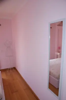 a mirror in a room with a bed and a dresser at Apartamento Felicidade in Almancil