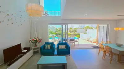 a living room with a blue couch and a tv at Luxury villa & private heatable pool in Albufeira in Albufeira