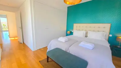 a bedroom with a large bed with a blue wall at Luxury villa & private heatable pool in Albufeira in Albufeira