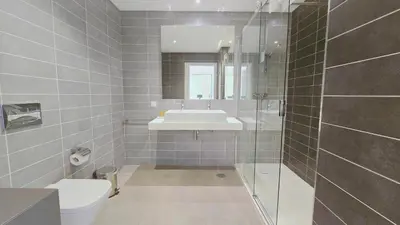 a bathroom with a toilet and a sink and a shower at Luxury villa & private heatable pool in Albufeira in Albufeira