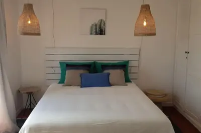 a bedroom with a large white bed with blue pillows at Old Village Design 3 Bedroom Townhouse in Vilamoura