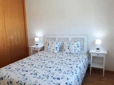 a bedroom with a blue and white bed with two night stands at AMM SeaView Marina Albufeira apartment in Albufeira