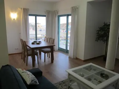 a living room with a table and a dining room at AMM SeaView Marina Albufeira apartment in Albufeira