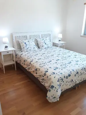 a bedroom with a large bed with blue and white sheets at AMM SeaView Marina Albufeira apartment in Albufeira