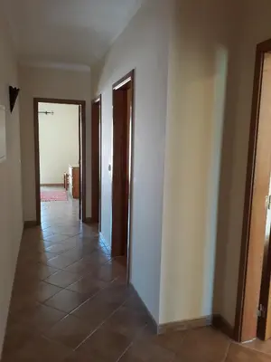 an empty hallway with two doors and a tile floor at AMM Albufeira Nice Hollydays apartment in Albufeira