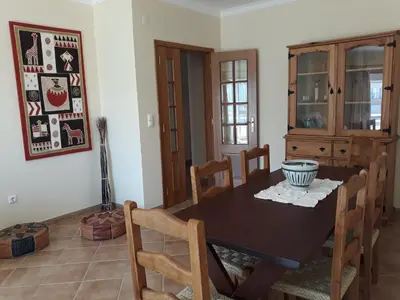 a dining room with a wooden table and chairs at AMM Albufeira Nice Hollydays apartment in Albufeira