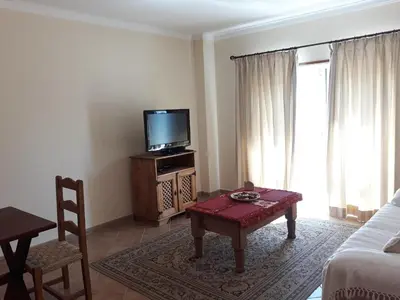 a living room with a tv and a coffee table at AMM Albufeira Nice Hollydays apartment in Albufeira