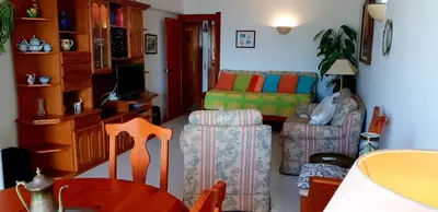 a living room with a couch and a chair at Varandas do Mar by Sunny Deluxe in Albufeira