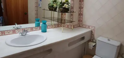 a bathroom with a sink and a mirror at Varandas do Mar by Sunny Deluxe in Albufeira