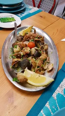 a plate of food with shrimp and vegetables on a table at Varandas do Mar by Sunny Deluxe in Albufeira