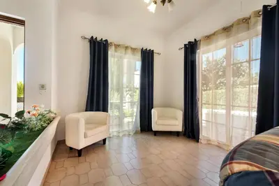 a kitchen and dining room with a table and chairs at A Fantastic Place for Families, Hilton Hotel are and close to amenities in Quarteira