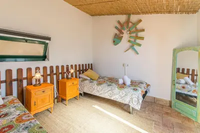 a bedroom with two beds and a mirror at Villa Rita in Silves